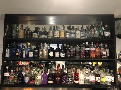 a shelf filled with lots of bottles of alcohol at Firth Hotel & Restaurant in Lossiemouth
