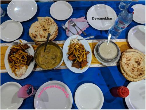a blue table with plates of food on it at Hotel Dewanekhas Skardu in Skardu