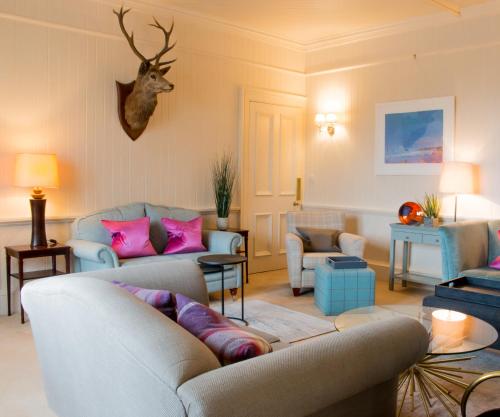 a living room with two couches and a deer head on the wall at The Airds Hotel and Restaurant in Port Appin