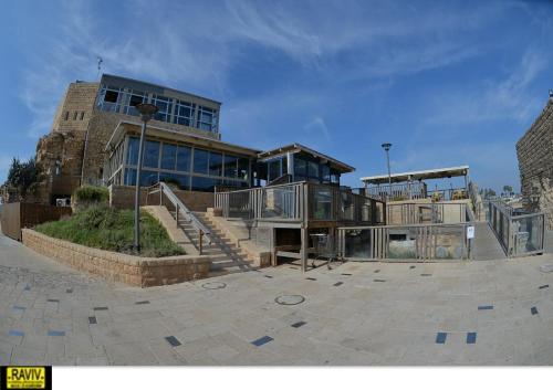 a large building with a staircase in front of it at Liz suite in Caesarea