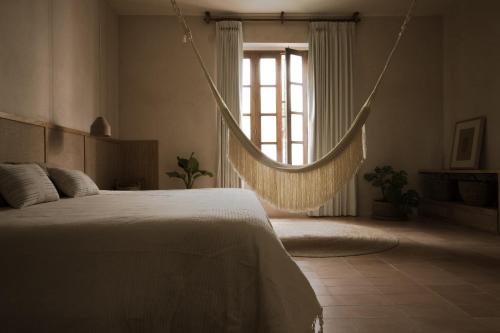 a bedroom with a bed and a window at Casa Montore by Barrio Mexico in Guadalajara