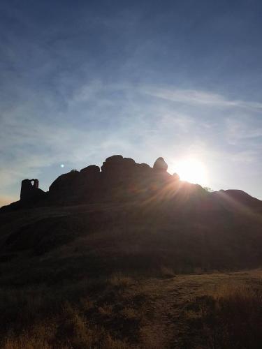a sun setting over a mountain with the sun shining on it at Markos Towers Apartments in Prilep