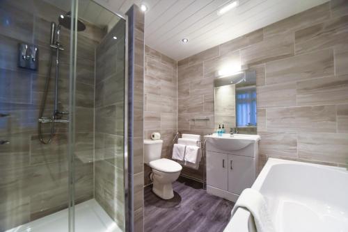 a bathroom with a toilet and a shower and a sink at The Bentley Brook Inn in Thorpe