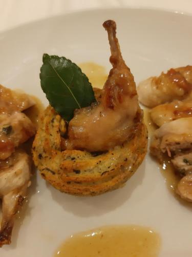 a plate of food with shrimp with a green leaf on it at locanda della pacchiana in San Salvatore Telesino