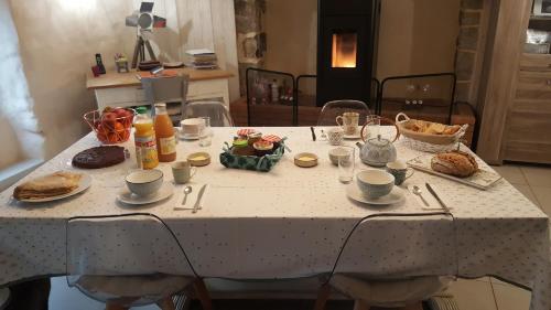 a table with a white table cloth with food on it at Le Domaine de Kerlys in Briec
