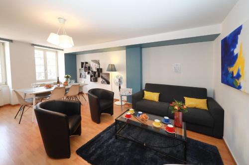 a living room with a couch and a table at COLMARAPPART Grand'Rue in Colmar
