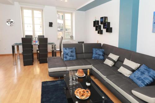 a living room with a couch and a table at COLMARAPPART Grand'Rue in Colmar