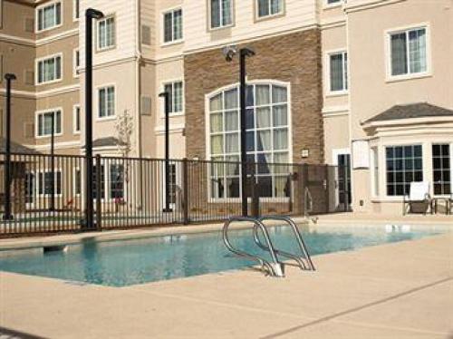 a swimming pool in front of a building at Staybridge Suites - Albuquerque Airport by IHG in Albuquerque