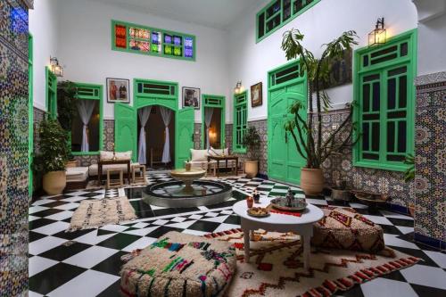 a living room with green and black and white tiles at Riad Rose Meryam in Marrakech