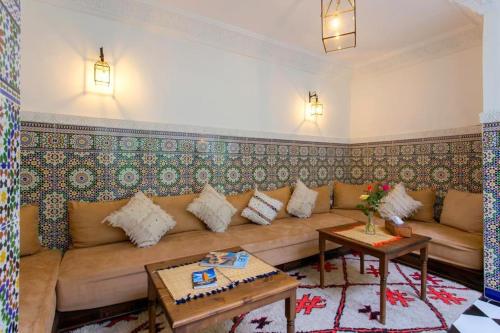 a living room with a couch and a table at Riad Rose Meryam in Marrakech