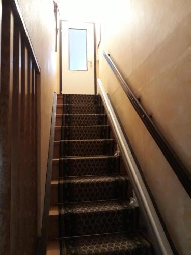 an escalator leading up to a door in a building at Das besondere Quartier in Berlin Pankow in Berlin