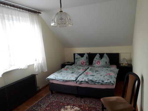 a bedroom with a bed and a chandelier at Das besondere Quartier in Berlin - Pankow in Berlin