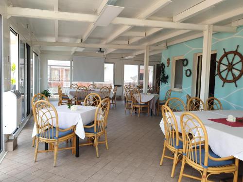 a dining room with tables and chairs and a table at La Lanterna in Silvi Marina