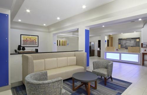 a lobby with a couch and two chairs and a table at Holiday Inn Express Boonville, an IHG Hotel in Boonville