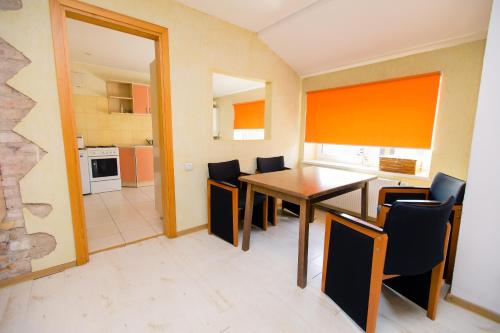 a kitchen and dining room with a table and chairs at Old Town Apartments in Alytus