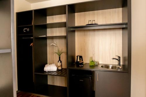 a kitchen with a sink and a counter with a sink at Hotel Campo in Renningen