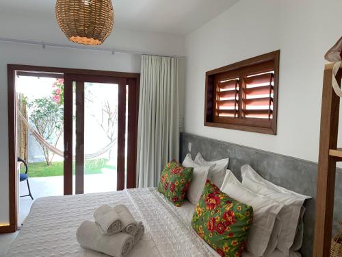 a bedroom with a bed with two towels on it at Pousada Tartaruga Boutique Hotel in Pipa