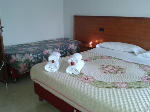 a hotel room with two beds with towels on the bed at Hotel Nappo in San Marzano sul Sarno