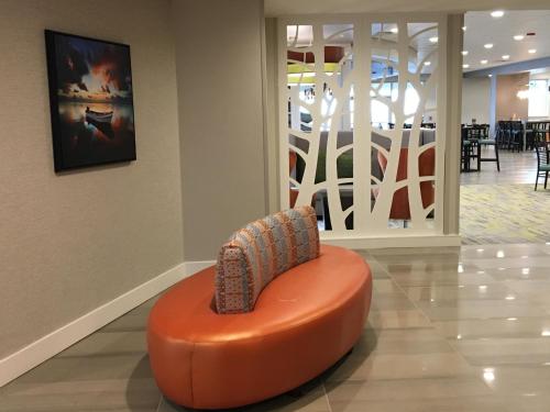an orange ottoman sitting in the middle of a lobby at Holiday Inn Hotel & Suites Daytona Beach On The Ocean by IHG in Daytona Beach