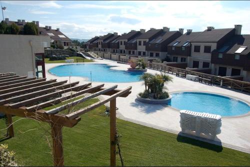 a large swimming pool with a row of buildings at COMPEJO RAEIROS O GROVE, S Vicente do Mar in O Grove
