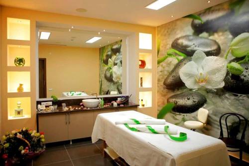 a room with a bed and a counter with a flower painting at A Modern Suite Close to Gondola Ski Lift in Bakuriani