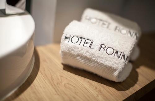 a hotel room towel sitting on a wooden table at Hotel Bonn in Mexico City