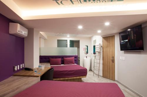 a bedroom with a purple bed in a room at Hotel Bonn in Mexico City
