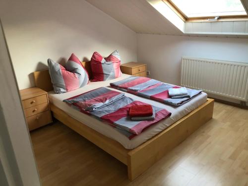 a bedroom with a bed with pillows and a window at Ferienwohnung Heidelberg ZE-2020-7-WZ in Heidelberg