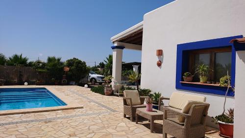a patio with chairs and a swimming pool at Villa en Sa Caleta - CAN BLAU IBIZA in Ibiza Town