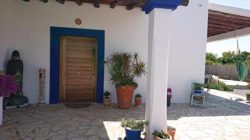 a front door of a house with potted plants at Villa en Sa Caleta - CAN BLAU IBIZA in Ibiza Town