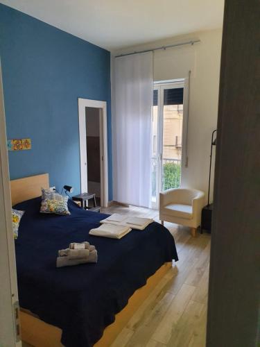a blue bedroom with a bed with towels on it at Casa del Moro in Cefalù