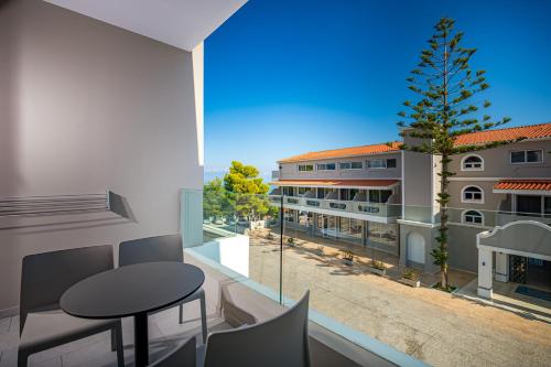 a room with a table and a view of a building at Alexandra Beach Resort & Spa in Tsilivi