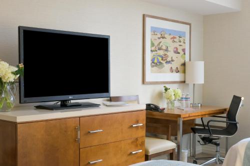 a television on a dresser in a room at Gateway Hotel Santa Monica in Los Angeles