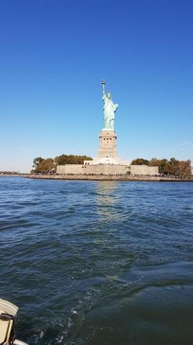 a view of the statue of liberty from the water at Cozy apt in WEST NY, NEW JERSEY, at 2 bloks from bus stop-15 minutes 2NY 7MINUTES VIA NYWATERWAY FERRY-BETTER CAN'T BE!! in West New York