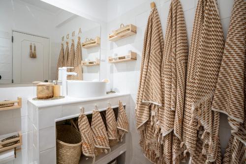 a bathroom with a sink and a towel rack at Baixa de Faro Rooftop in Faro