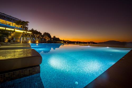 a hotel swimming pool at night with the lights on at Alexandra Beach Resort & Spa in Tsilivi