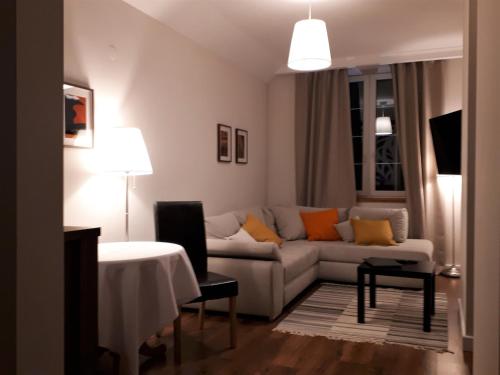 a living room with a couch and a table at Zajazd Podzamcze in Fałków