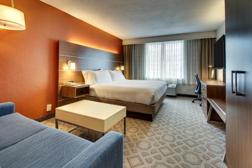a hotel room with two beds and a desk at Holiday Inn Express Poughkeepsie by IHG in Poughkeepsie