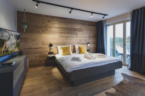 a bedroom with a large bed and a wooden wall at Mariandl am Meer in Binz