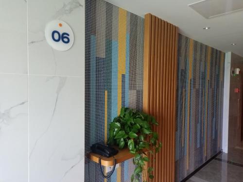 a wall with a phone and a plant in a hallway at Holiday Inn Express Xi'an Qujiang South by IHG in Xi'an