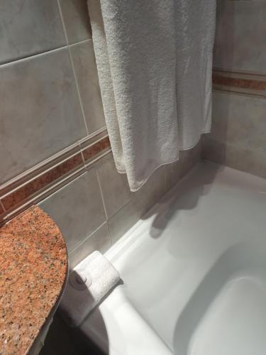 a bath tub in a bathroom with a towel at Departamento Céntrico in Rosario