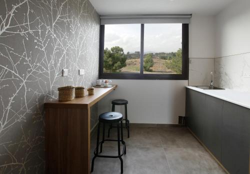a bathroom with a counter and a sink and a window at Cosmopolis Multi-Venue in Larnaca
