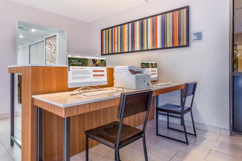 a office with a desk with a computer and two chairs at Holiday Inn Express Ramsey Mahwah by IHG in Ramsey