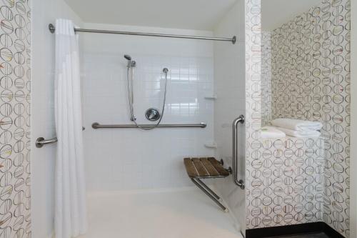 a bathroom with a shower with a shower curtain at Holiday Inn & Suites Pittsfield-Berkshires by IHG in Pittsfield