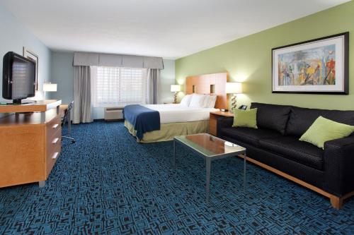 a hotel room with a bed and a couch at Holiday Inn Express Hotel & Suites Rock Springs Green River by IHG in Rock Springs