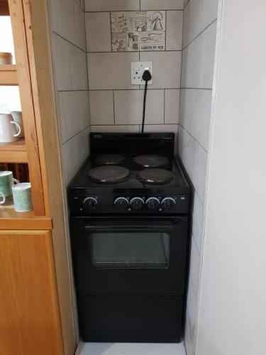a small black stove in a small kitchen at Bethel B&B / Selfcatering in George