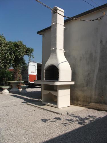 a building with an outdoor oven on the side of a building at CASA ROMAN ITALIA, Center Sacile in Sacile