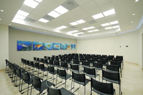 a room with rows of chairs and paintings on the wall at Holiday Inn Express Puerto Vallarta by IHG in Puerto Vallarta