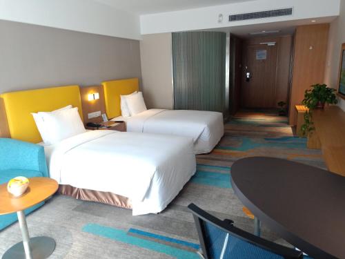 a hotel room with two beds and a table at Holiday Inn Express Xi'an Qujiang South by IHG in Xi'an