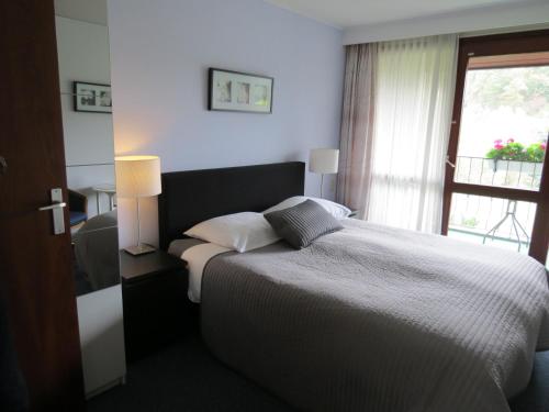 a bedroom with a large bed and a window at Hotel Schilberg in Slenaken
